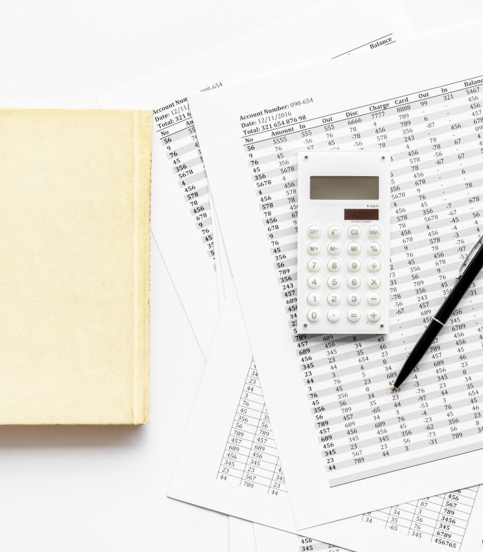 Financial literature. Books near documents, calculator on white background top-down.